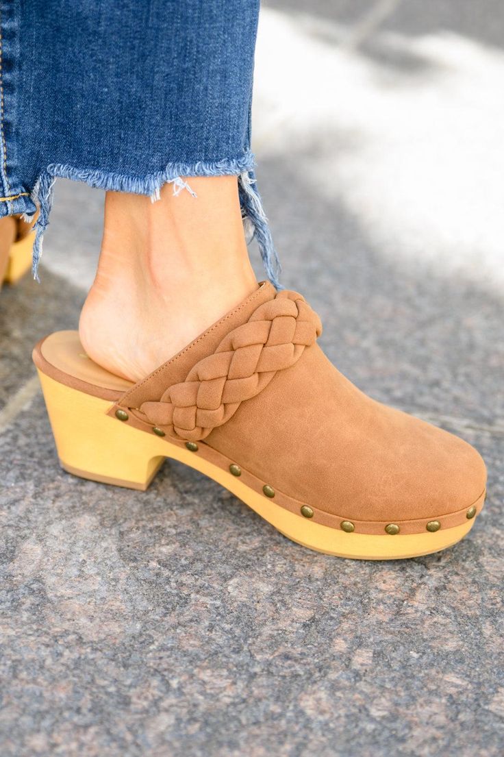 Take cute to a whole new level this season in the Taylor Braided Clogs In Brown! A smooth faux leather shapes a rounded toe with braided detail and wooden sole decorated in metal studs. Pair these cute clogs with all your fall fits for a complete look! True to size + Lightweight Faux leather + Matte Approx. 2 3/4" heel Keywords: Clog, Mule, Braided, Brown, Shoe Casual Clogs With Woven Sole And Round Toe, Casual Brown Clogs With Studded Rubber Outsoles, Trendy Synthetic Clogs With Wooden Heel, Trendy Brown Synthetic Clogs, Synthetic Clogs With Woven Sole And Round Toe, Casual Open Toe Clogs With Studded Outsoles, Halloween Graphic Tees, Fall Fits, Brown Shoe