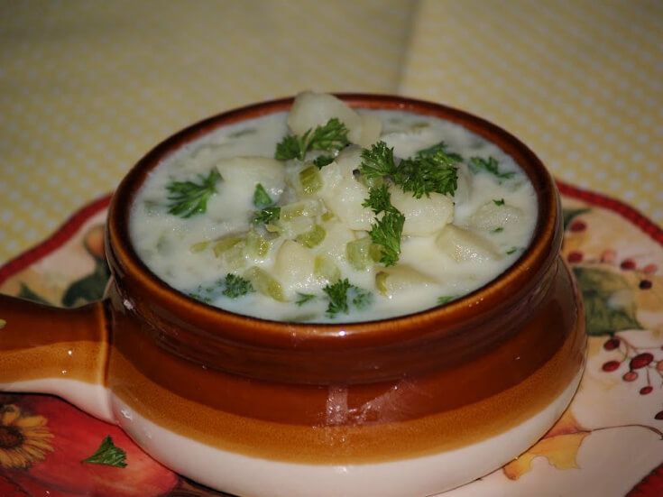 a bowl filled with food sitting on top of a table next to a flowered place mat