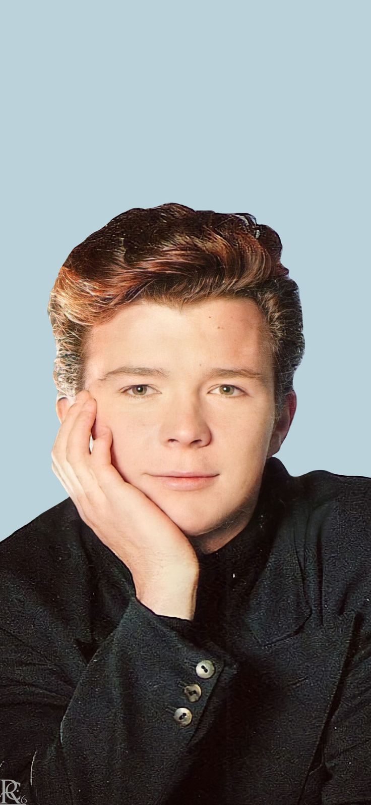 a young man with his hand on his chin looking at the camera while wearing a black shirt