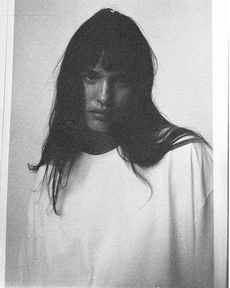 a black and white photo of a woman with long hair