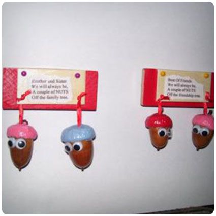 three acorns are hanging on the wall with red tags attached to them that say, don't touch