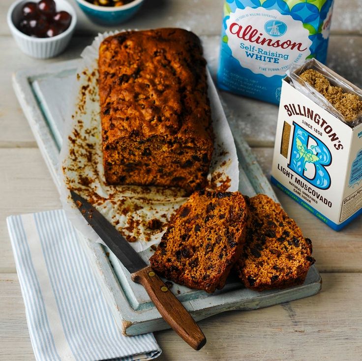 a loaf of banana bread sitting on top of a table next to some fruit and yogurt