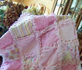 a pink and white blanket sitting on top of a table