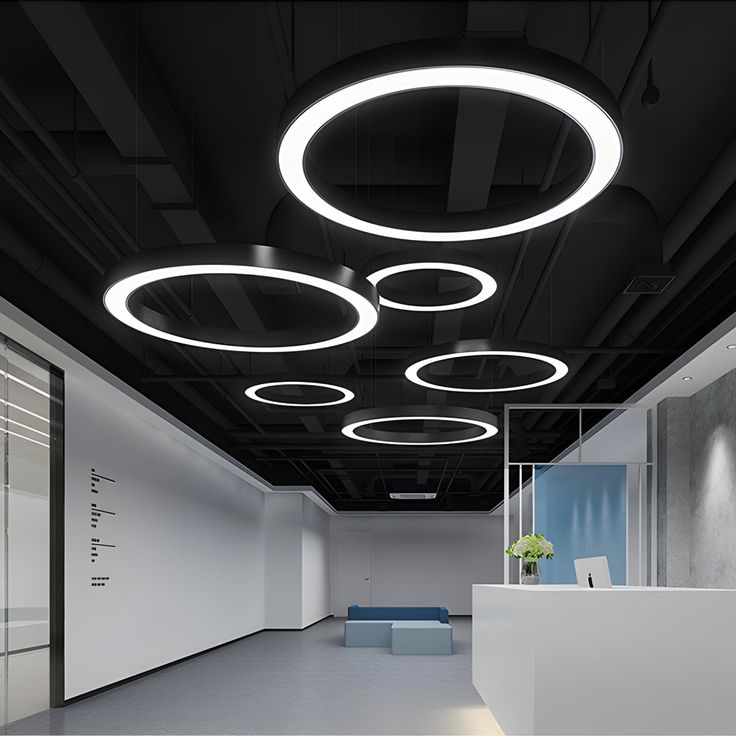 an empty office with round lights and white walls