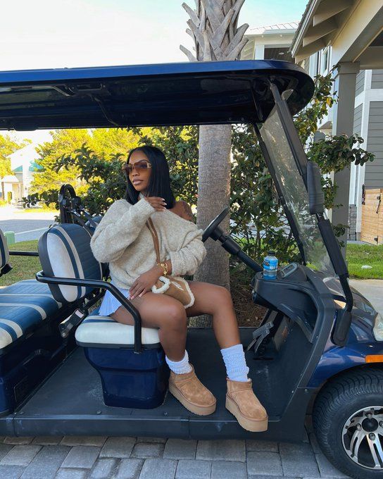 a woman sitting on top of a blue golf cart