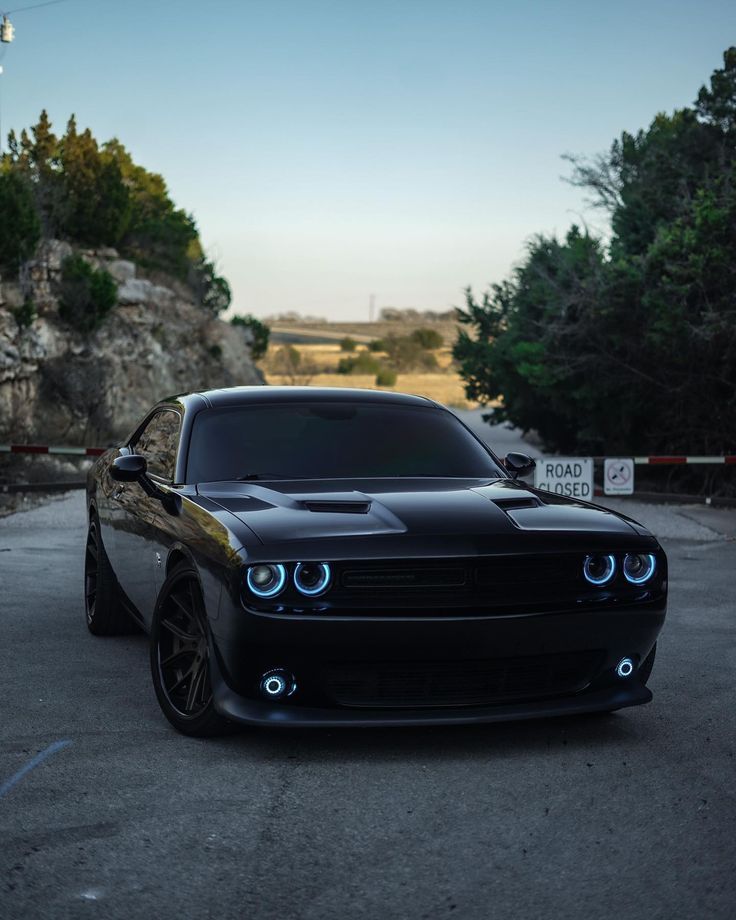 a black car is parked on the street