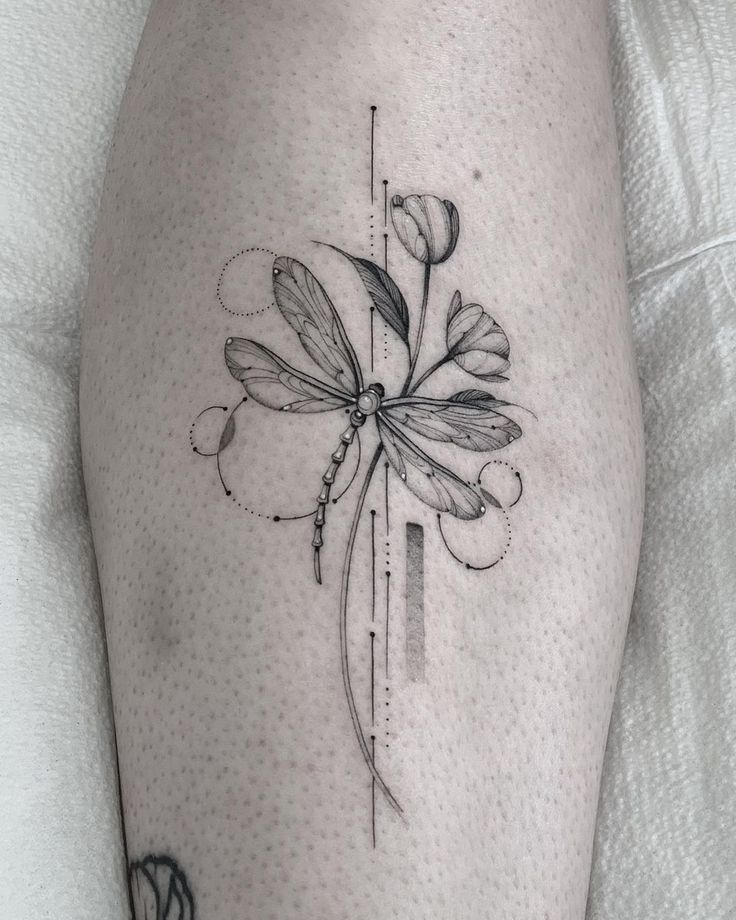 a black and white photo of a flower on the thigh