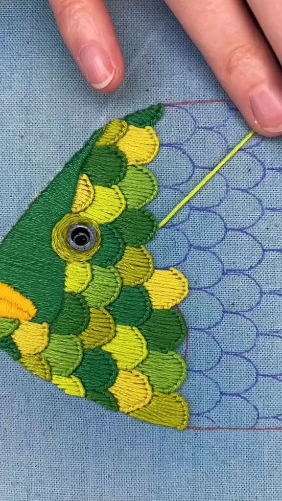 someone is stitching on the back of a piece of fabric