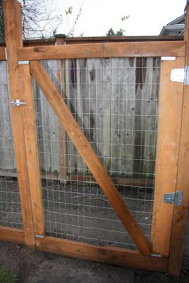 a wooden gate with wire around it