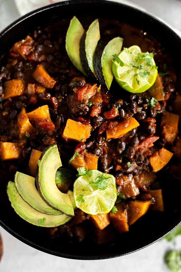 a bowl filled with chili, avocado and sweet potatoes