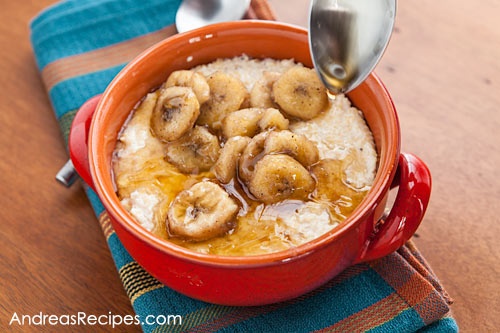 a red bowl filled with oatmeal topped with banana slices