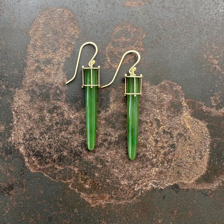 These Jade Torpedo Earrings feature an eye-catching design crafted from 18k gold and authentic jade. The verdant gem is uniquely Captured in 18k gold to create an elegant and dynamic look, perfect for any occasion. 18k gold, jade. 2 1/8 inch length. Luxury Green Jade Earrings, Yellow Gold Jade Earrings, Modern Yellow Gold Jade Jewelry, Luxury Green Earrings With Polished Finish, Modern Green Earrings With Polished Finish, Modern Green 14k Gold Earrings, Jade Stone, Hook Earrings, Design Crafts