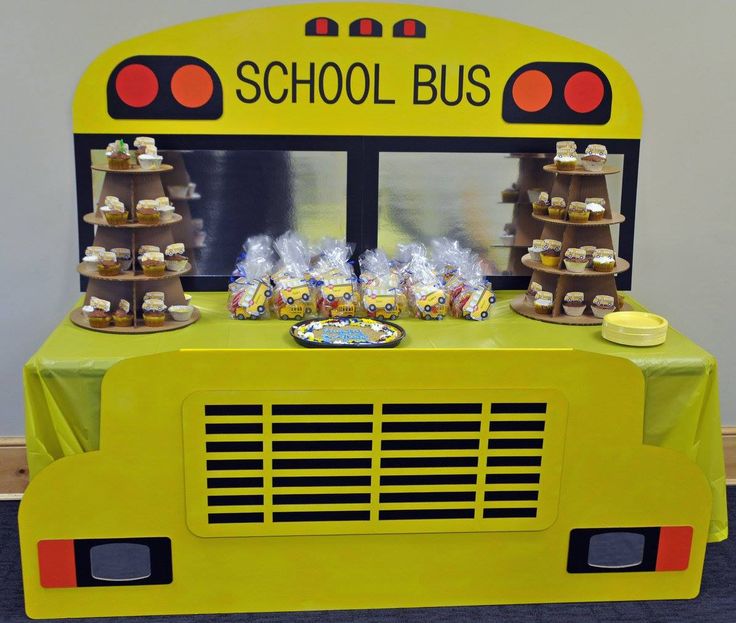 a yellow school bus table with snacks on it