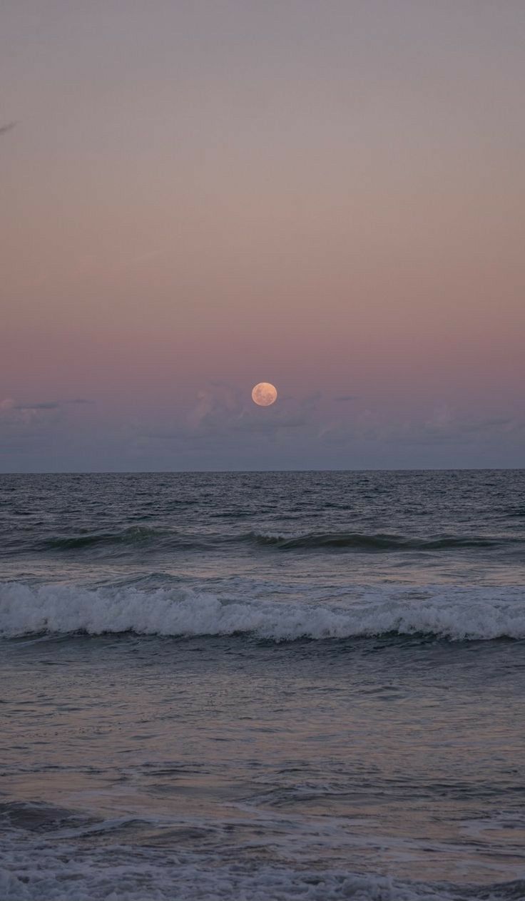 the sun is setting over the ocean with waves