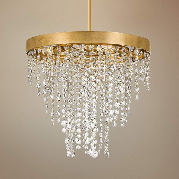 a gold chandelier with crystal drops hanging from it