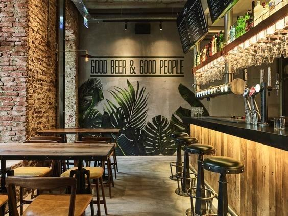 the inside of a restaurant with wooden tables and stools