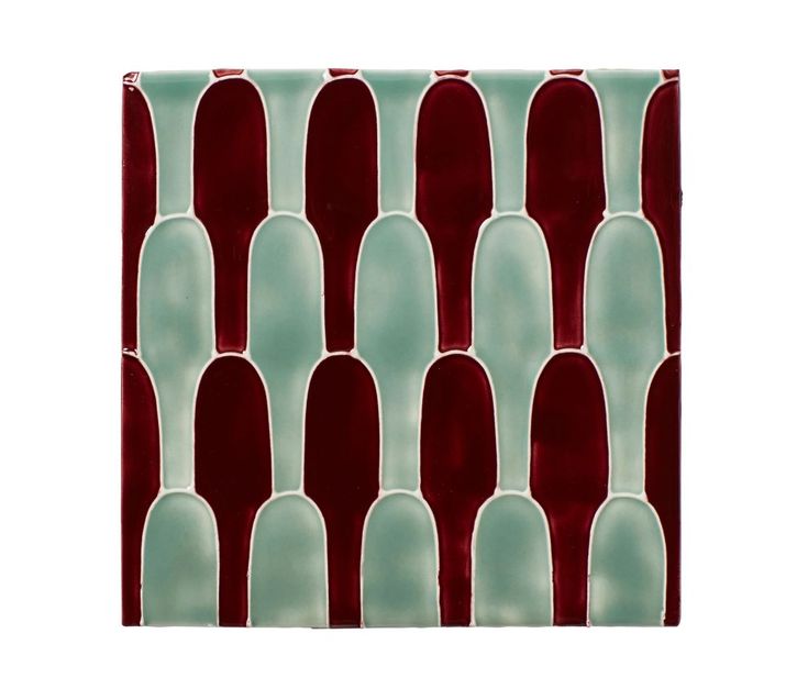 a red and green glass tile pattern on a white wall