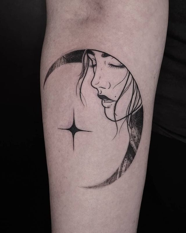 a woman's face with a crescent tattoo on her arm