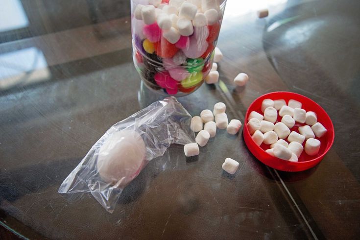 there are candy and marshmallows on the table