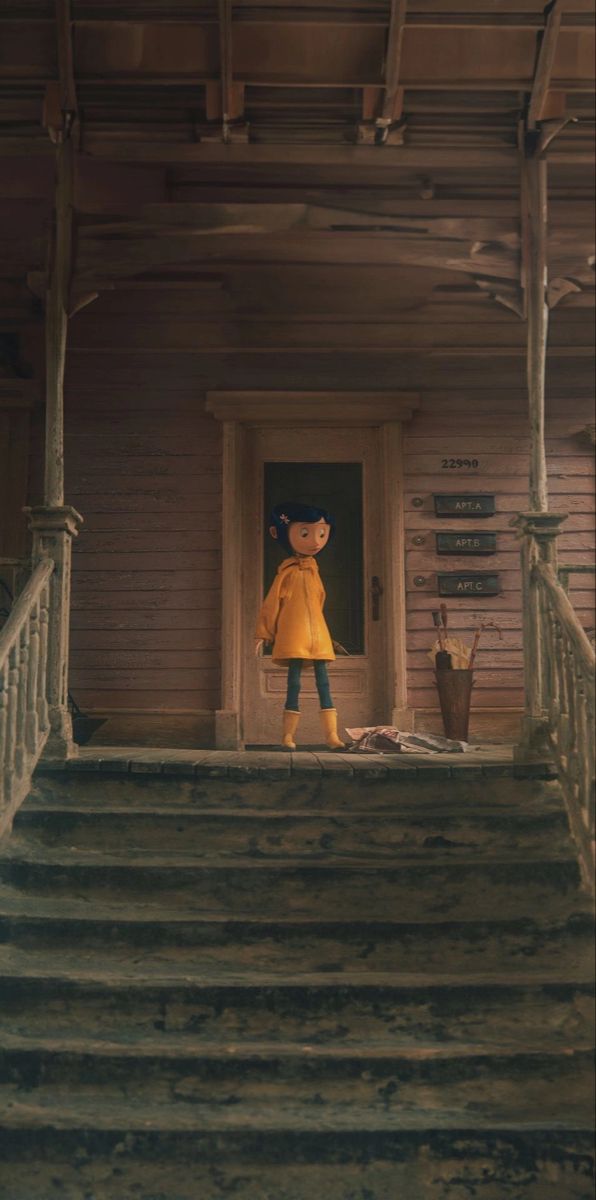 a teddy bear standing on the steps of a house