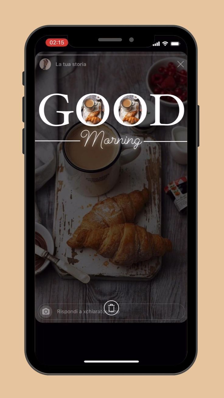 an iphone with the words good morning on it and some croissants next to it