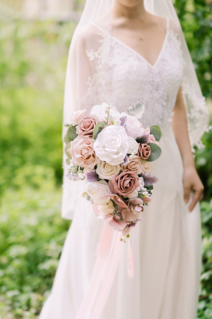 a woman in a wedding dress holding a bouquet