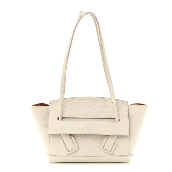 This is an authentic BOTTEGA VENETA Grainy Calfskin Small Arco in Plaster. This stylish shoulder bag is crafted of white grained calfskin leather. The bag features a basket shape, with smooth looping leather shoulder straps, and gold hardware. The front flap opens to a brown suede leather interior with a hanging zipper pocket. Bottega Veneta Crossbody Bag, Bottega Veneta Arco, Bottega Veneta Bags, Stylish Shoulder Bag, Purple Bags, Mini Crossbody Bag, White Bag, Leather Interior, Small Bag