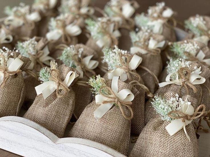 burlap bags filled with baby's breath flowers on top of a book