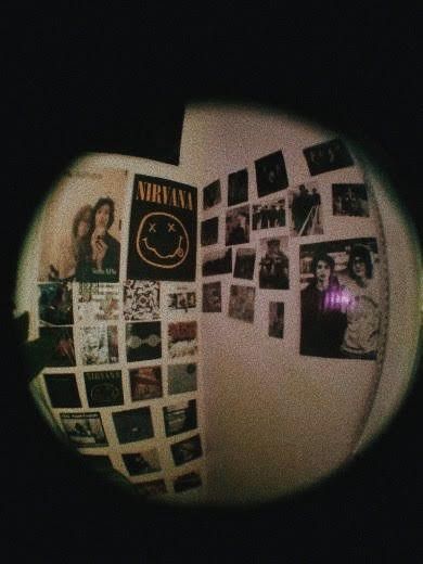 a wall covered in photos and pictures with the words nirvana on it