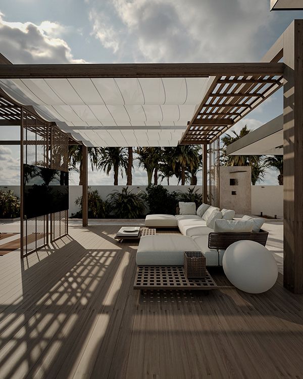 an outdoor living area with couches and tables