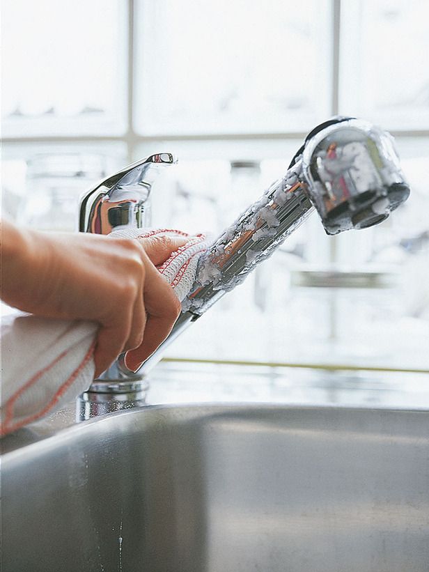 a person is washing their hands in a stainless steel sink with the faucet running