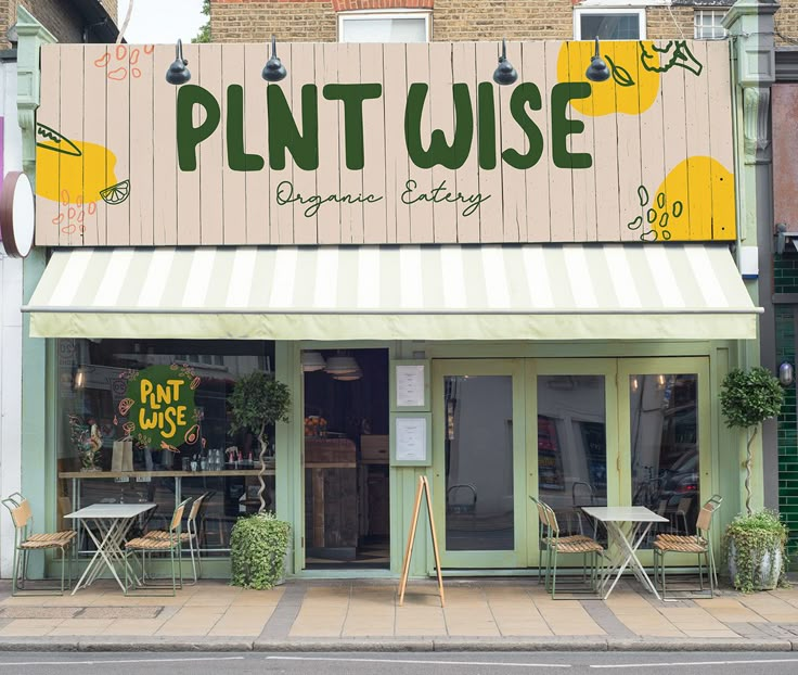 a store front with tables and chairs on the sidewalk in front of it that says plant wise