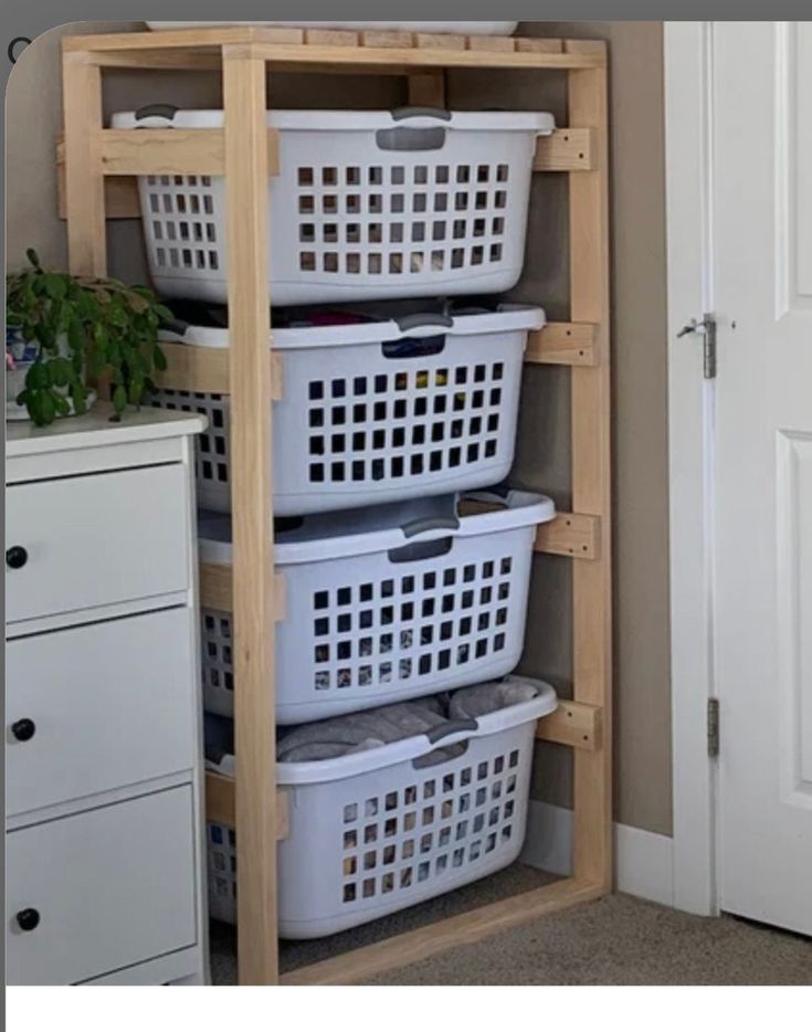 three baskets are stacked on top of each other in the corner of a room with an open door