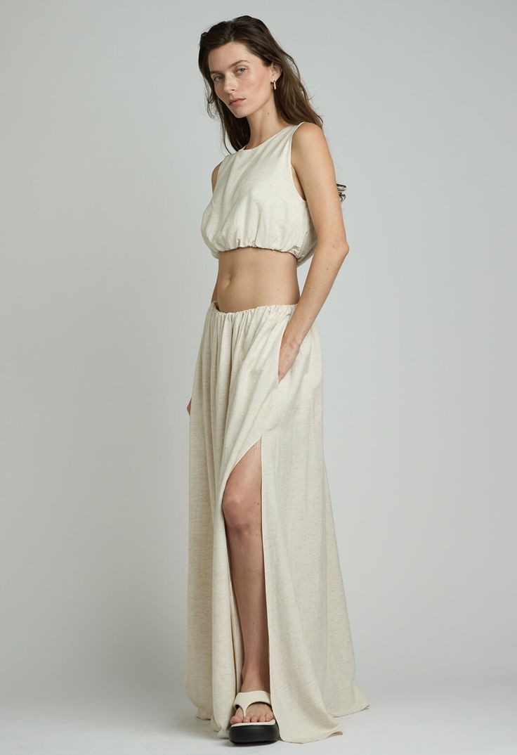 One Size. Fits XS-LColor: Natural LinenElastic WaistLined Maxi LengthLow RiseSide Slit60% Rayon 40% LinenDry Clean RecommendedBy The NKC Store Product Measurements:Waist: 71.12-101.6cm / 28-40inLength: 104.14cm / 41in Stretch Maxi Length Bottoms With Side Slits, Stretch Maxi Bottoms With Side Slits, Fitted Maxi Length Bottoms With Side Slits, Spring Beach Skirt With Split Hem, Fitted Cropped Beach Skirt, Cropped Fitted Beach Skirt, Fitted Cropped Skirt For The Beach, Chic Vacation Skirt With Side Slits, Fitted Split Maxi Skirt For Vacation