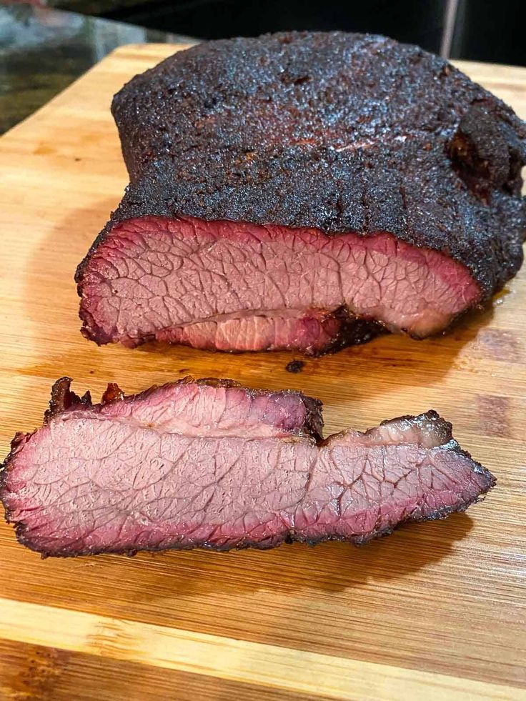 a large piece of meat sitting on top of a wooden cutting board