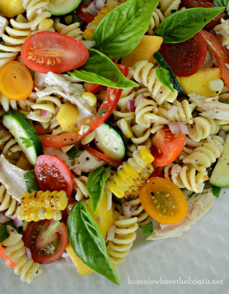 pasta salad with tomatoes, cucumbers, and other vegetables