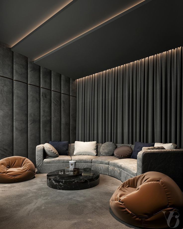 a living room filled with lots of furniture next to a tall wall covered in black drapes