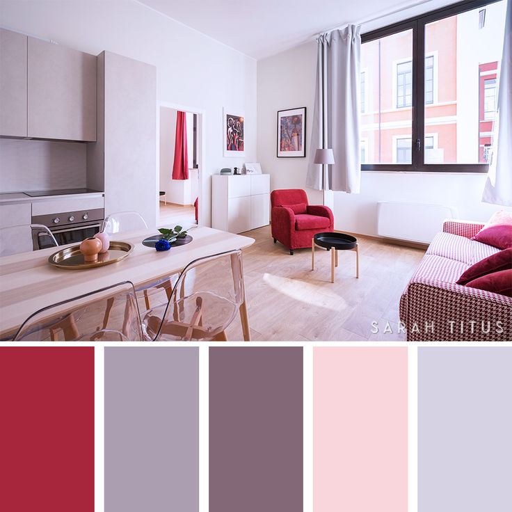 a living room filled with furniture next to a window and a table in front of it