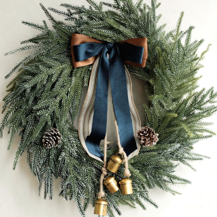 a christmas wreath with bells and pine cones