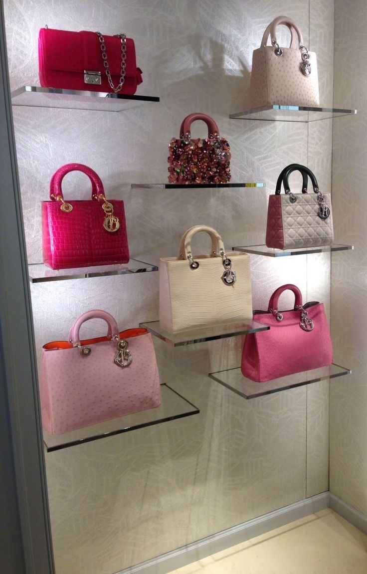 a display case filled with lots of different colored purses