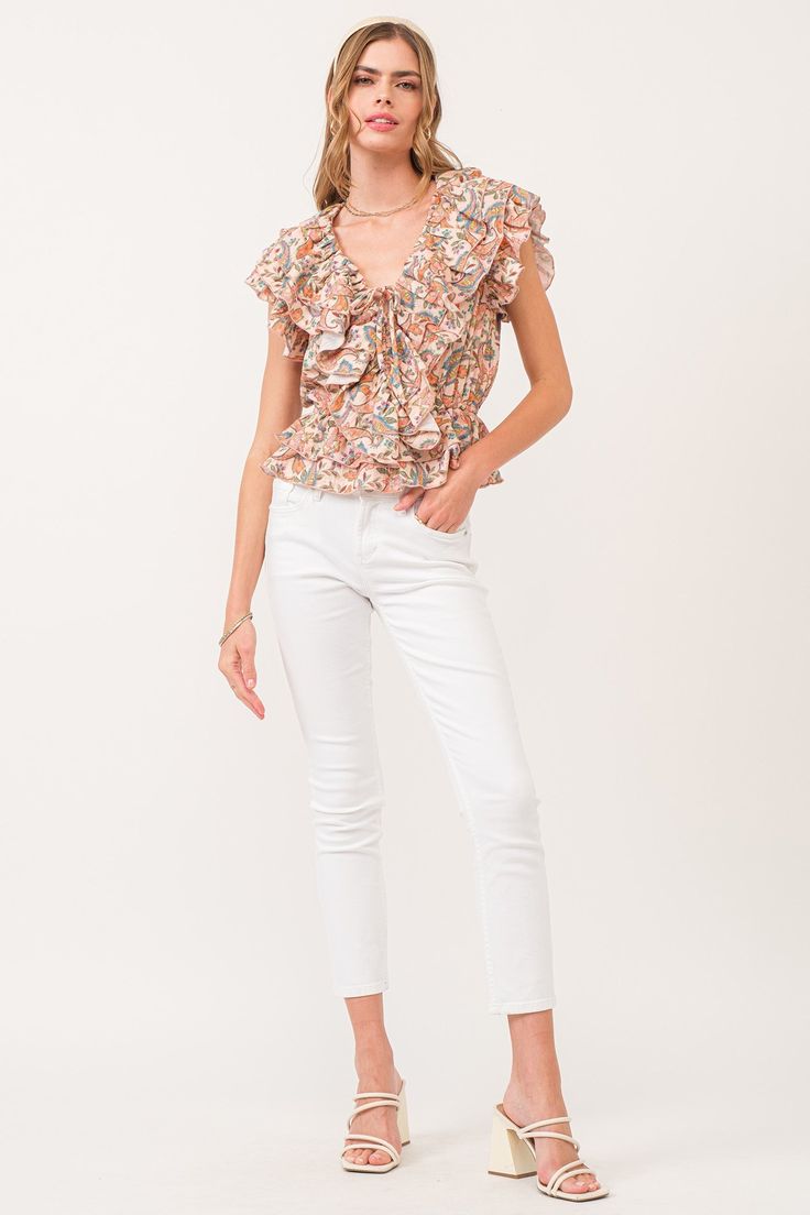 Multi ruffle top, v-neck front with spaghetti self neck ties & elastic waist. Multi print woven on standard fit. Gracing a soiree & strolling through sun-kissed day, whispers of sophistication & ever desired...Body length from HPS: 22", Armhole ruffle: 5 1/2", Bust: 39" (Size Small) 100% COTTON Machine wash cold, Tumble dry low Imported Spring Floral Print V-neck Smocked Top, White V-neck Smocked Top For Spring, Spring V-neck Top With Elastic Waistband, Fitted V-neck Top With Elastic Waistband, Chic Smocked V-neck Top With Ruffles, Floral Print Smocked V-neck Top For Brunch, Chic Spring Smocked Top With Elastic Waistband, Chic Smocked Top With Elastic Waistband For Spring, Casual V-neck Smocked Top With Floral Print