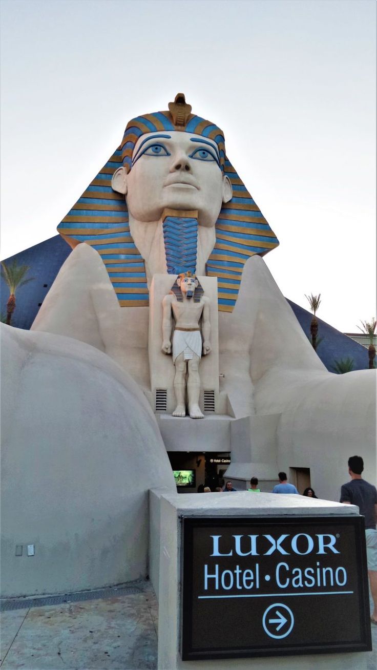 an egyptian themed hotel in las vegas, with a sphinx statue and casino sign on the front