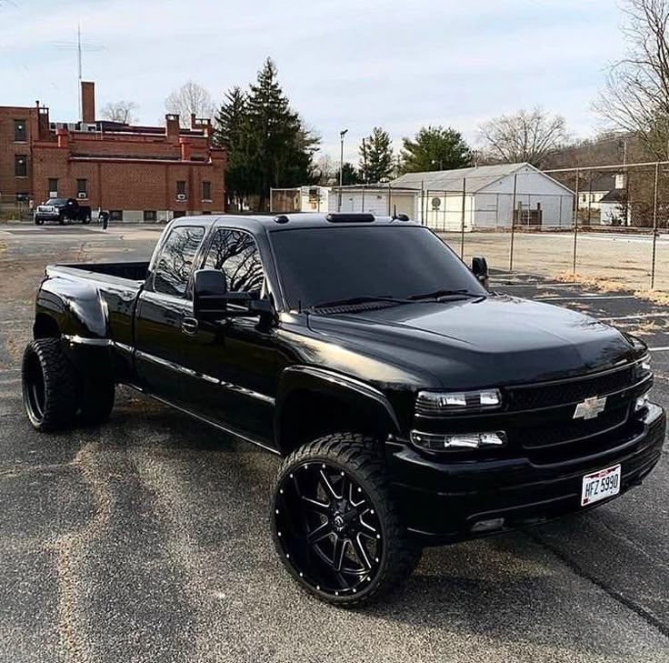 a black truck parked in a parking lot