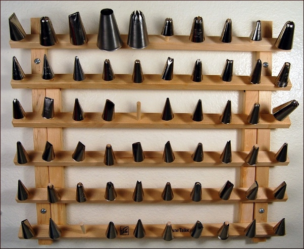 a wooden shelf with many black and white objects on it