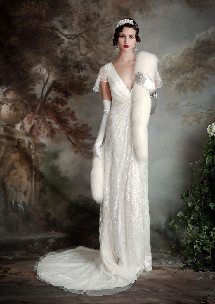 a woman in a white dress and fur stole