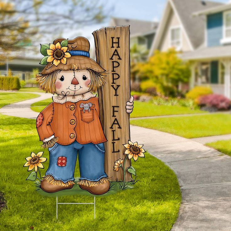 a lawn decoration with a scarecrow holding a sign that says happy fall on it