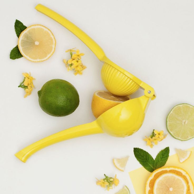 lemons, limes and other fruit are arranged on a white surface