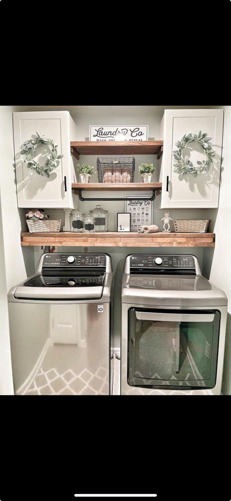 an image of a kitchen setting with stove and washer in the middle, white cabinets