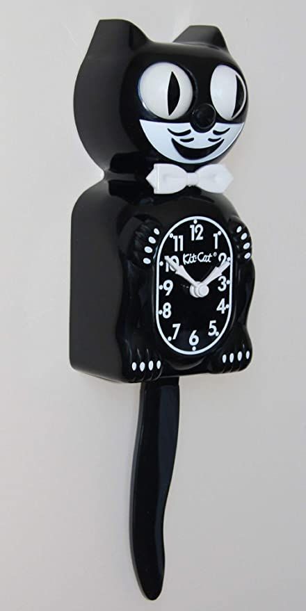 a black cat clock is hanging on the wall