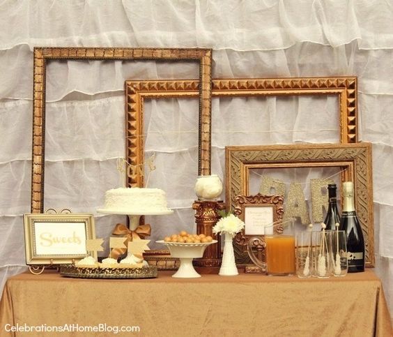 a table topped with framed pictures and cakes